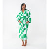 woman with dark skin and black hair models a green and white checkerboard terry towel dressing gown